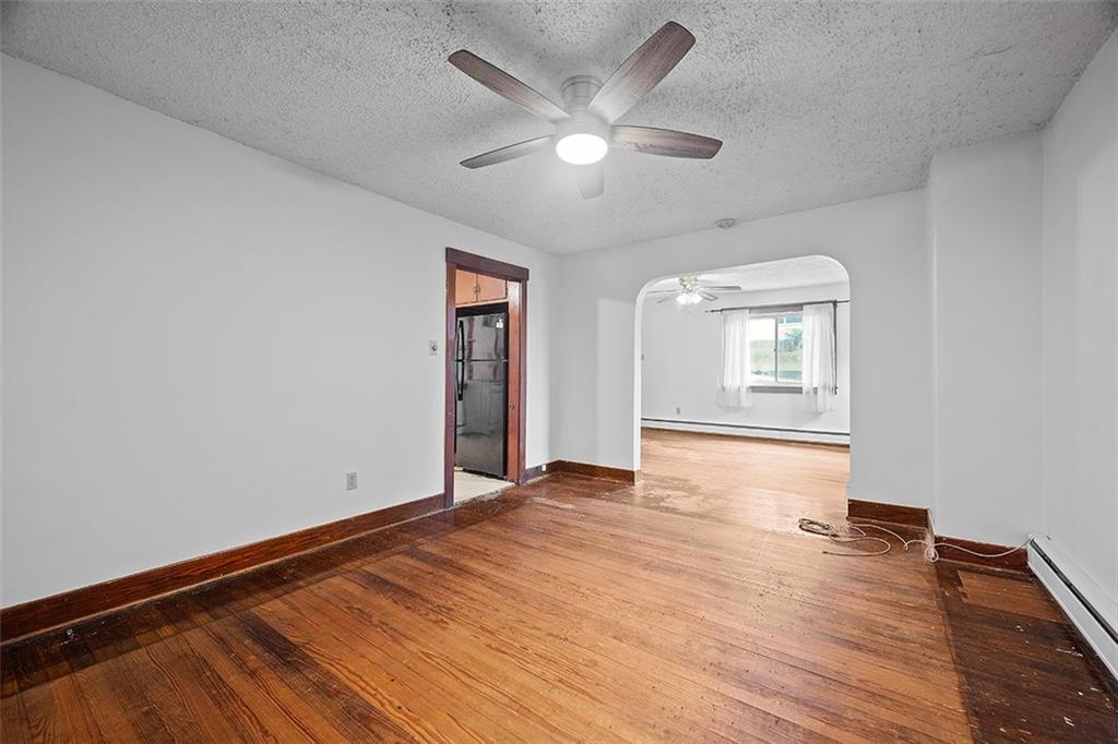 3708 Grant Street Pittsburgh, PA 15234 - Photo 7 of 36 an empty room with wooden floor and windows