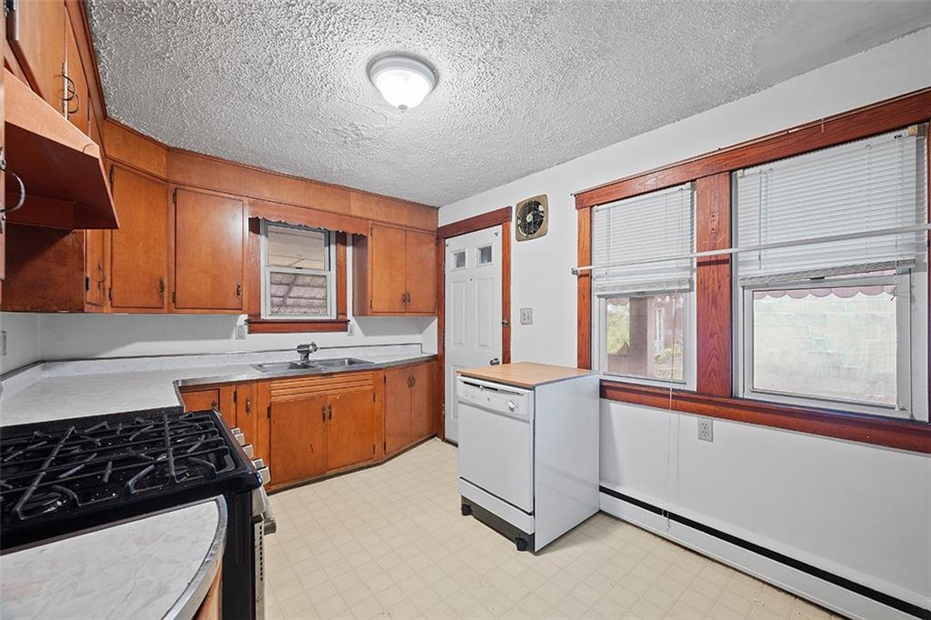 3708 Grant Street Pittsburgh, PA 15234 - Photo 8 of 36 a kitchen that has a lot of cabinets in it and a window