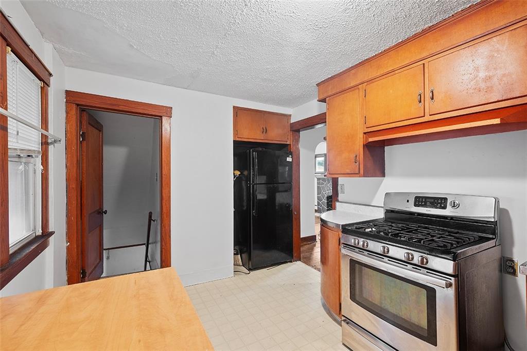3708 Grant Street Pittsburgh, PA 15234 - Photo 10 of 36 a kitchen with stainless steel appliances granite countertop a stove and a refrigerator