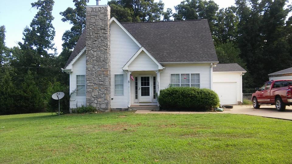 1001 Anderson Road Dickson, TN 37055 - Photo 1 of 9 a view of a house with a yard and garage