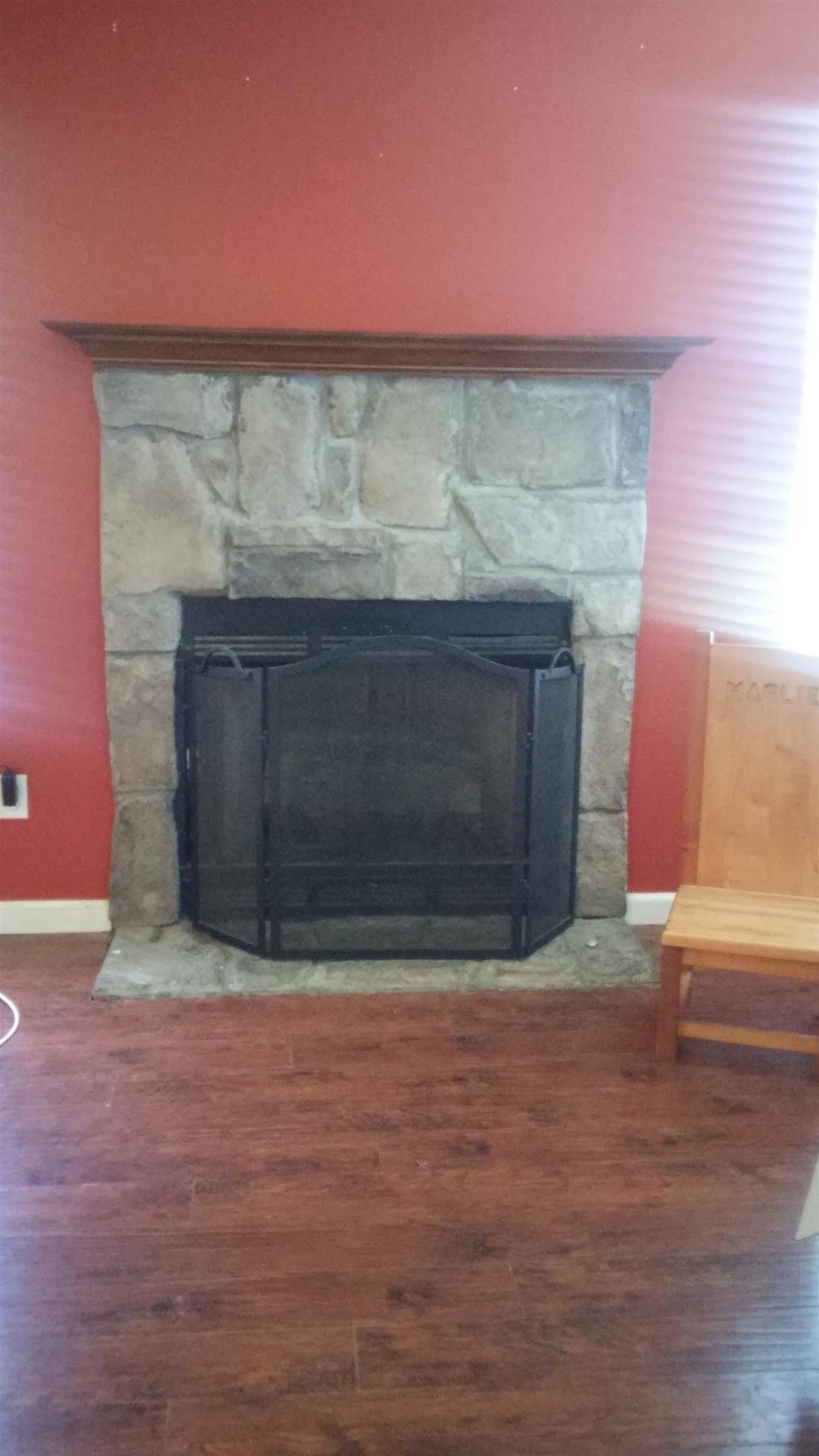 1001 Anderson Road Dickson, TN 37055 - Photo 5 of 9 a view of an empty room with wooden floor and a fireplace