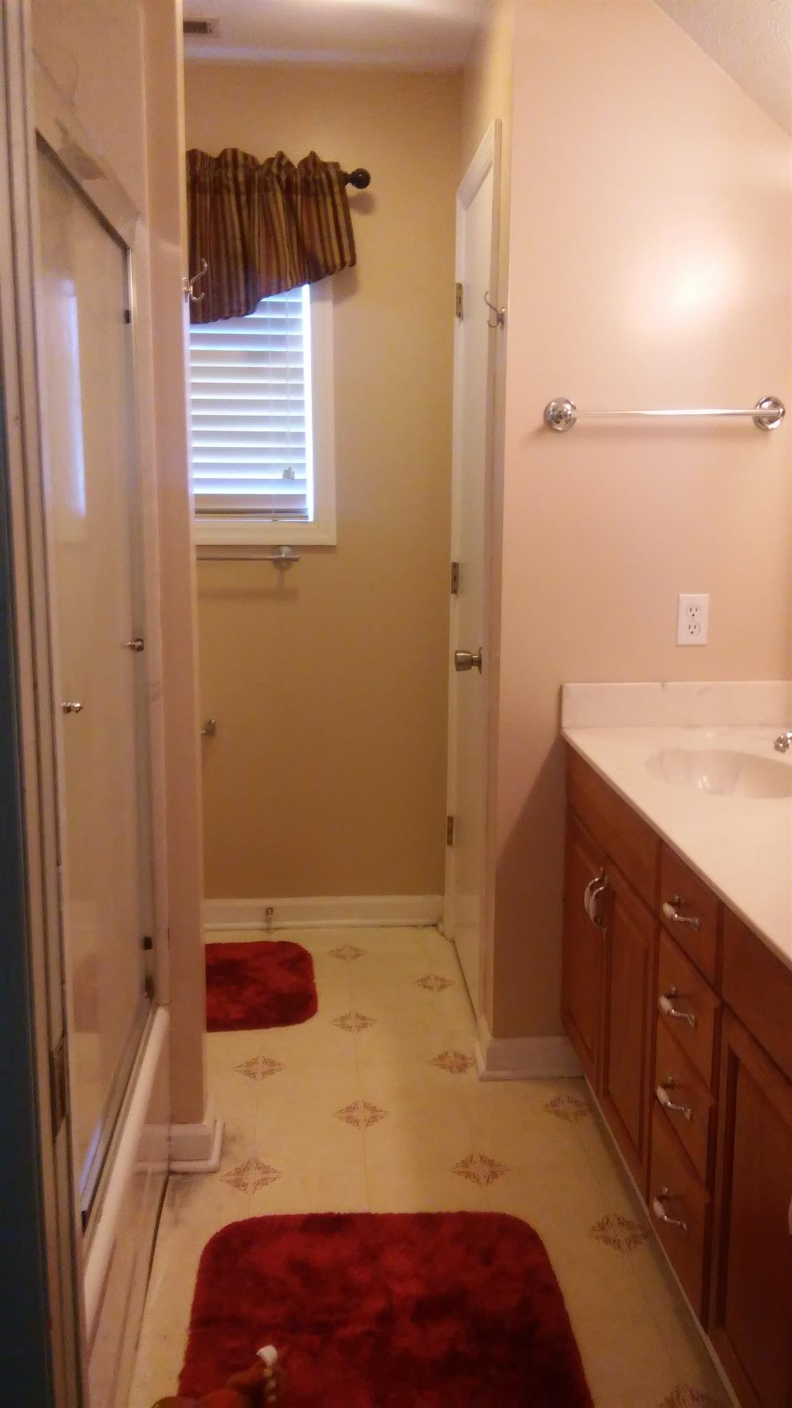 1001 Anderson Road Dickson, TN 37055 - Photo 8 of 9 a bedroom with a sink and a mirror