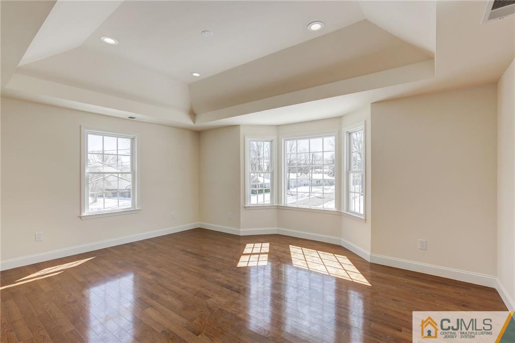 29 Fairfax Road Edison, NJ 08817 - Photo 12 of 21 a view of an empty room with wooden floor and a window