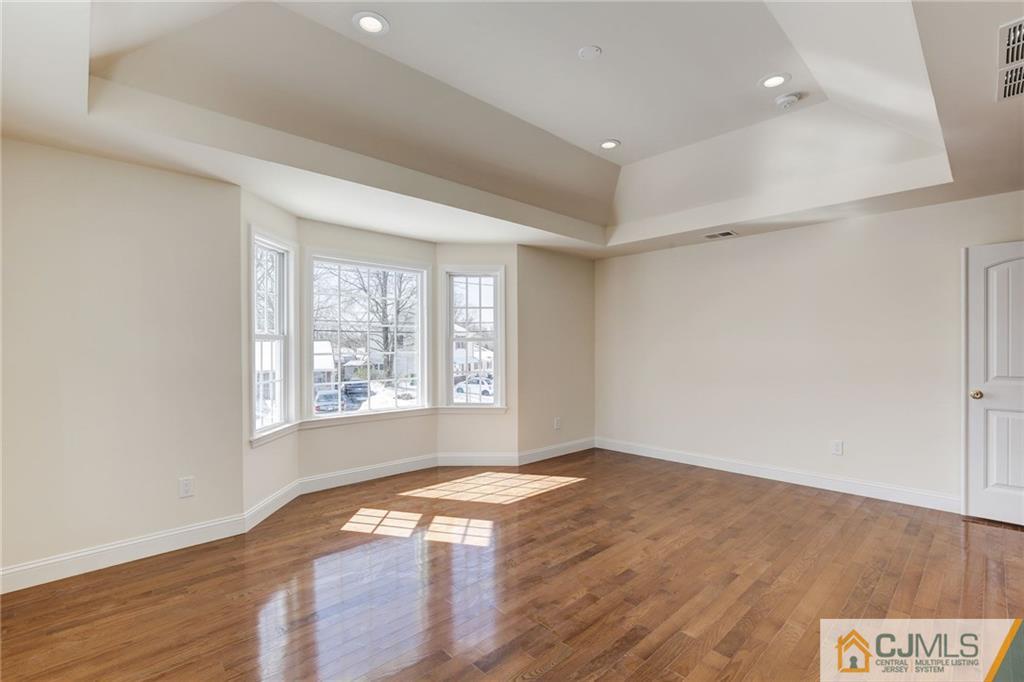 29 Fairfax Road Edison, NJ 08817 - Photo 13 of 21 a view of an empty room with wooden floor and a window