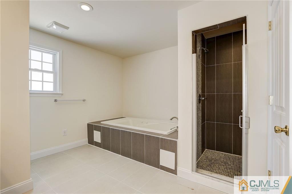 29 Fairfax Road Edison, NJ 08817 - Photo 15 of 21 a bathroom with a tub and a shower