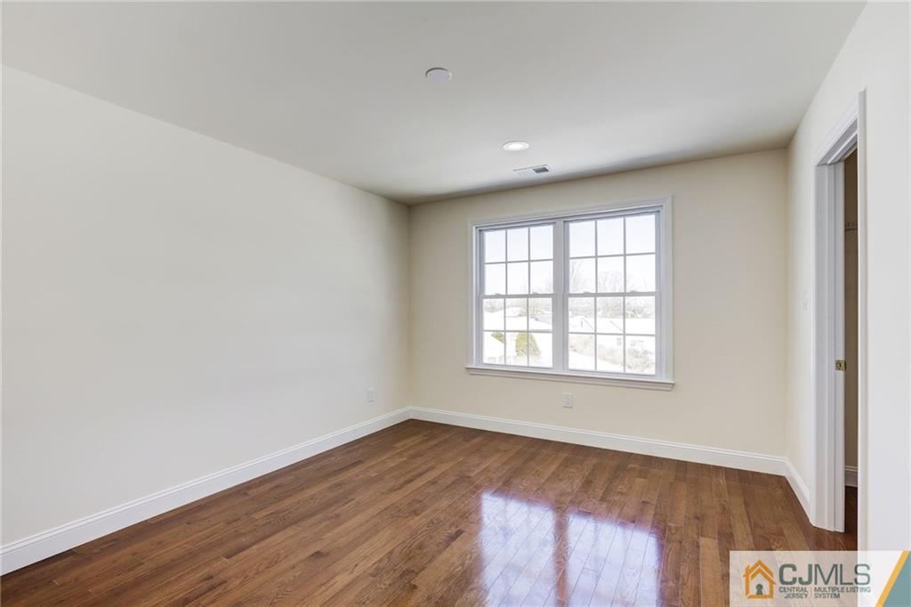 29 Fairfax Road Edison, NJ 08817 - Photo 18 of 21 an empty room with wooden floor and windows