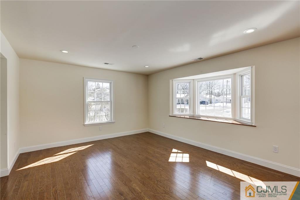 29 Fairfax Road Edison, NJ 08817 - Photo 3 of 21 a view of an empty room with wooden floor and a window