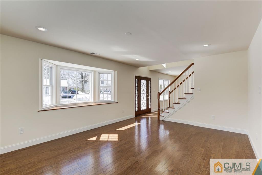 29 Fairfax Road Edison, NJ 08817 - Photo 5 of 21 a view of an empty room with wooden floor and a window