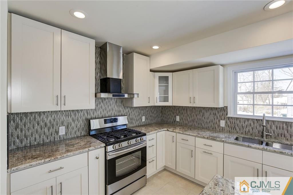 29 Fairfax Road Edison, NJ 08817 - Photo 6 of 21 a kitchen with granite countertop a sink stove and cabinets