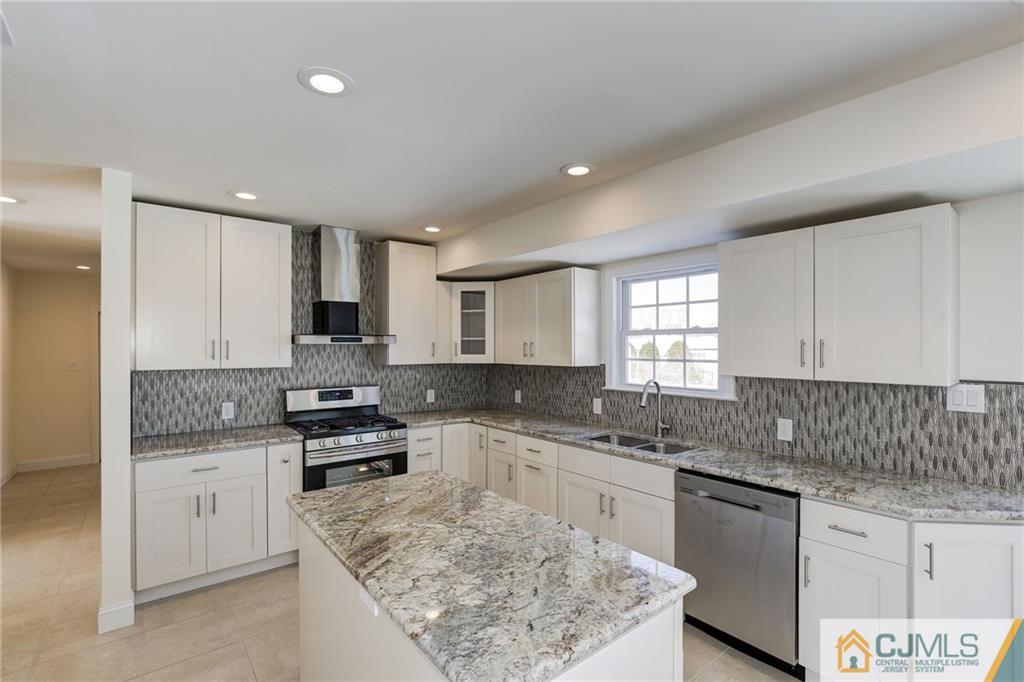 29 Fairfax Road Edison, NJ 08817 - Photo 7 of 21 a kitchen with stainless steel appliances granite countertop a sink stove and cabinets
