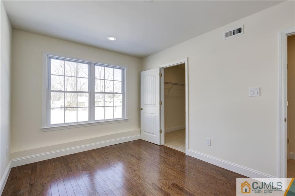 29 Fairfax Road Edison, NJ 08817 - Photo 8 of 21 an empty room with wooden floor and windows