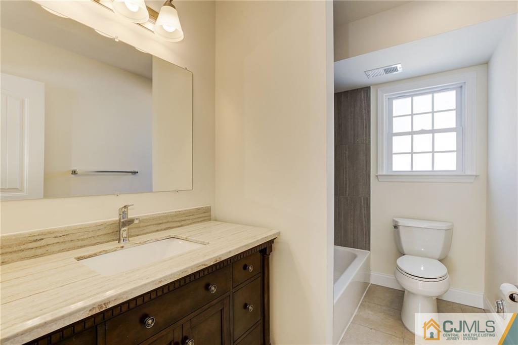 29 Fairfax Road Edison, NJ 08817 - Photo 9 of 21 a bathroom with a sink a toilet and a mirror