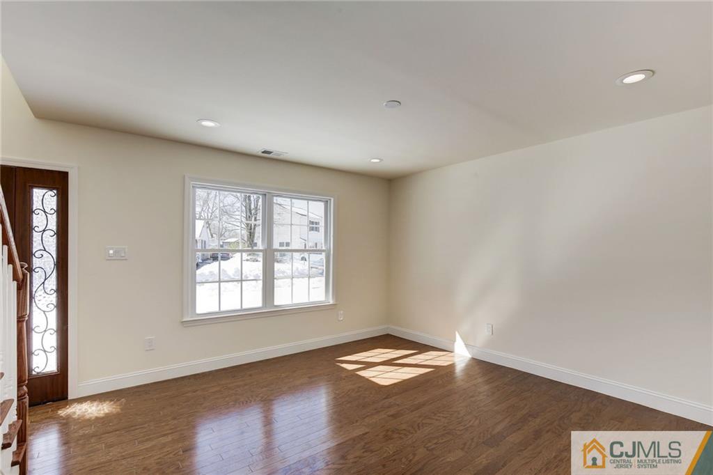 29 Fairfax Road Edison, NJ 08817 - Photo 10 of 21 a view of empty room with wooden floor and fan