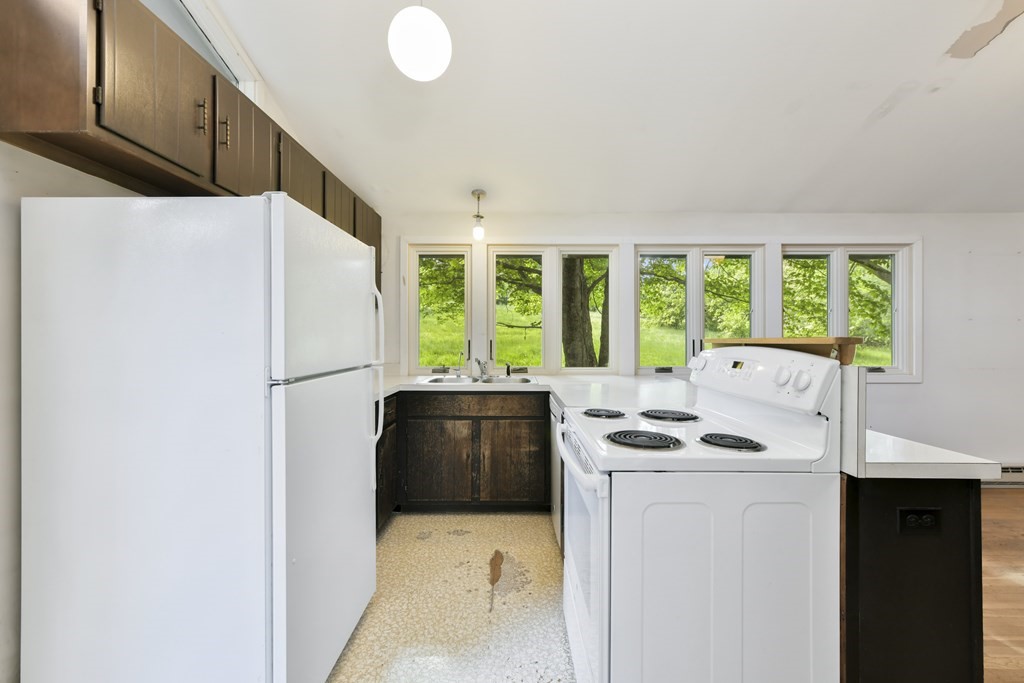 34 Westcott Road Harvard, MA 01451 - Photo 8 of 29 a kitchen with stainless steel appliances a refrigerator sink and stove