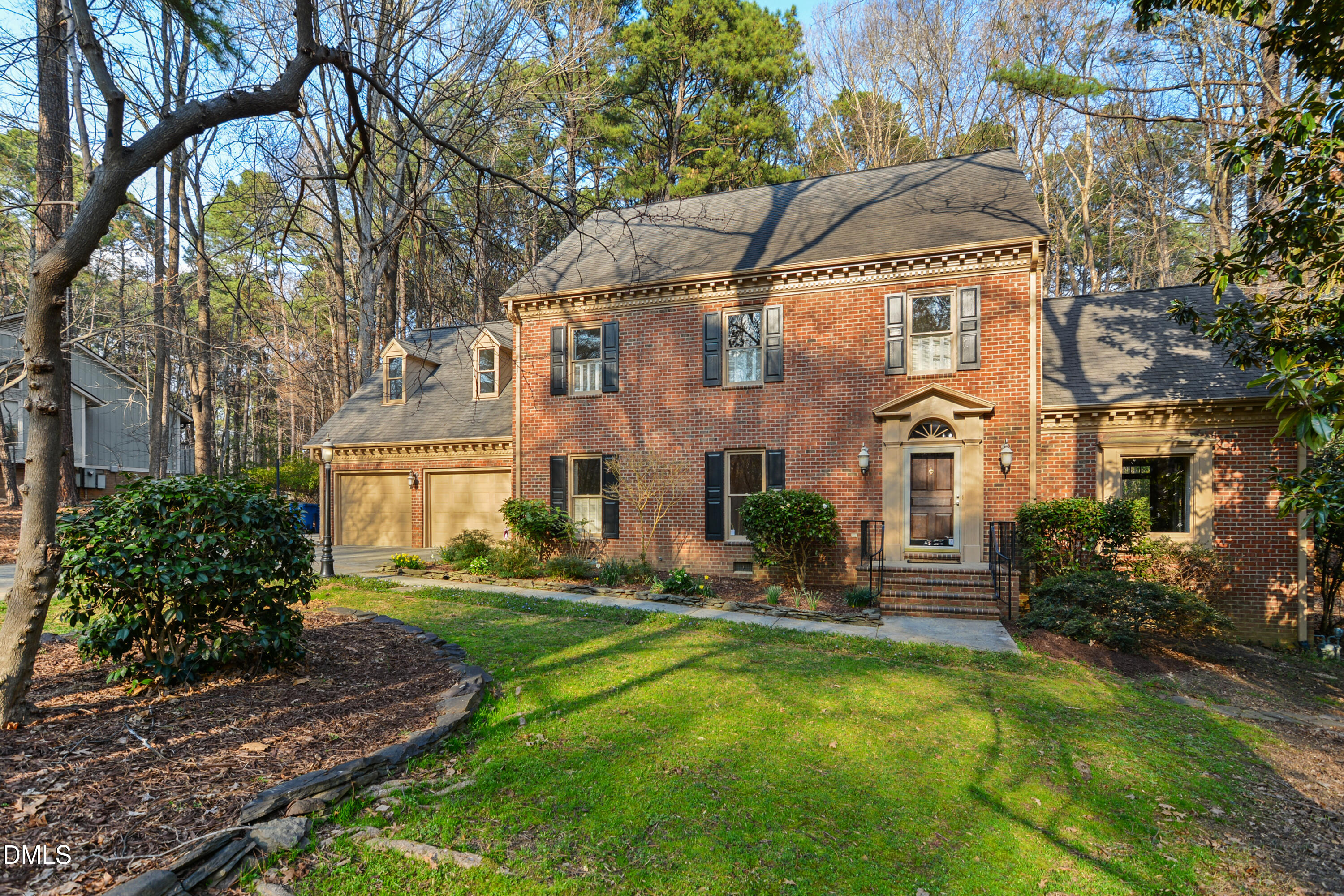 a view of house with yard and sitting area