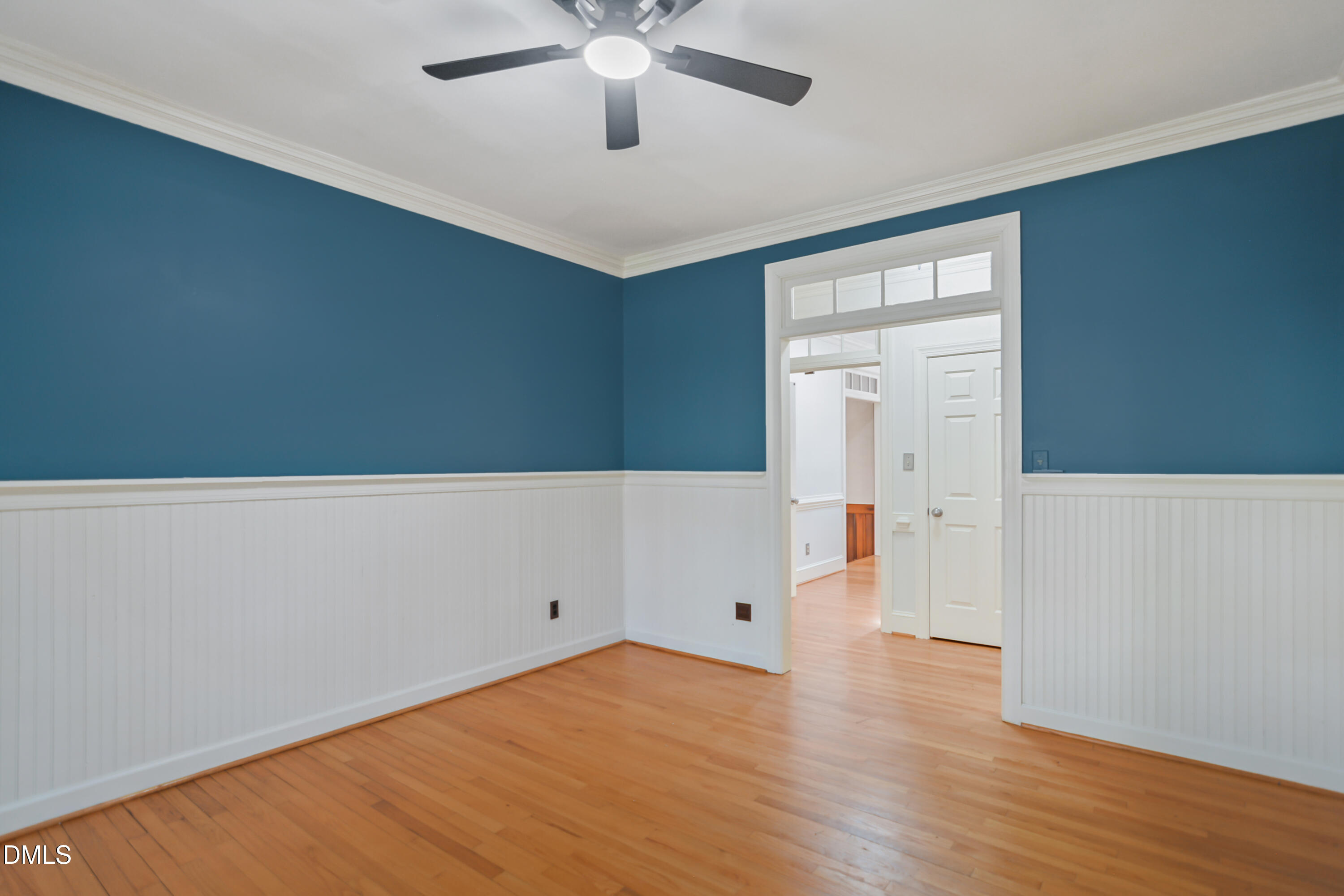 5008 Wood Valley Drive Raleigh, NC 27613 - Photo 13 of 37 an empty room with wooden floor and ceiling fan