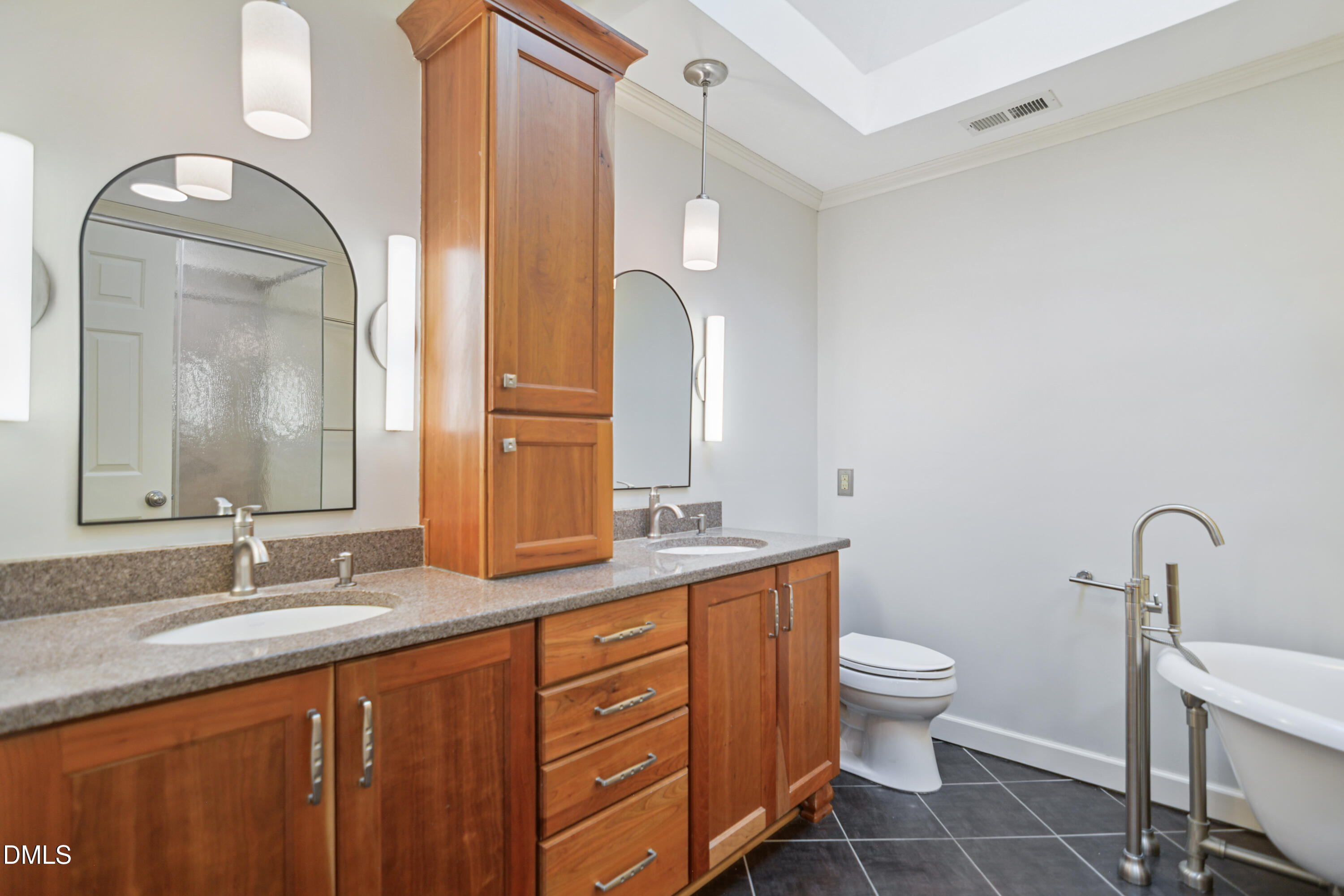5008 Wood Valley Drive Raleigh, NC 27613 - Photo 16 of 37 a bathroom with a double vanity sink and a mirror
