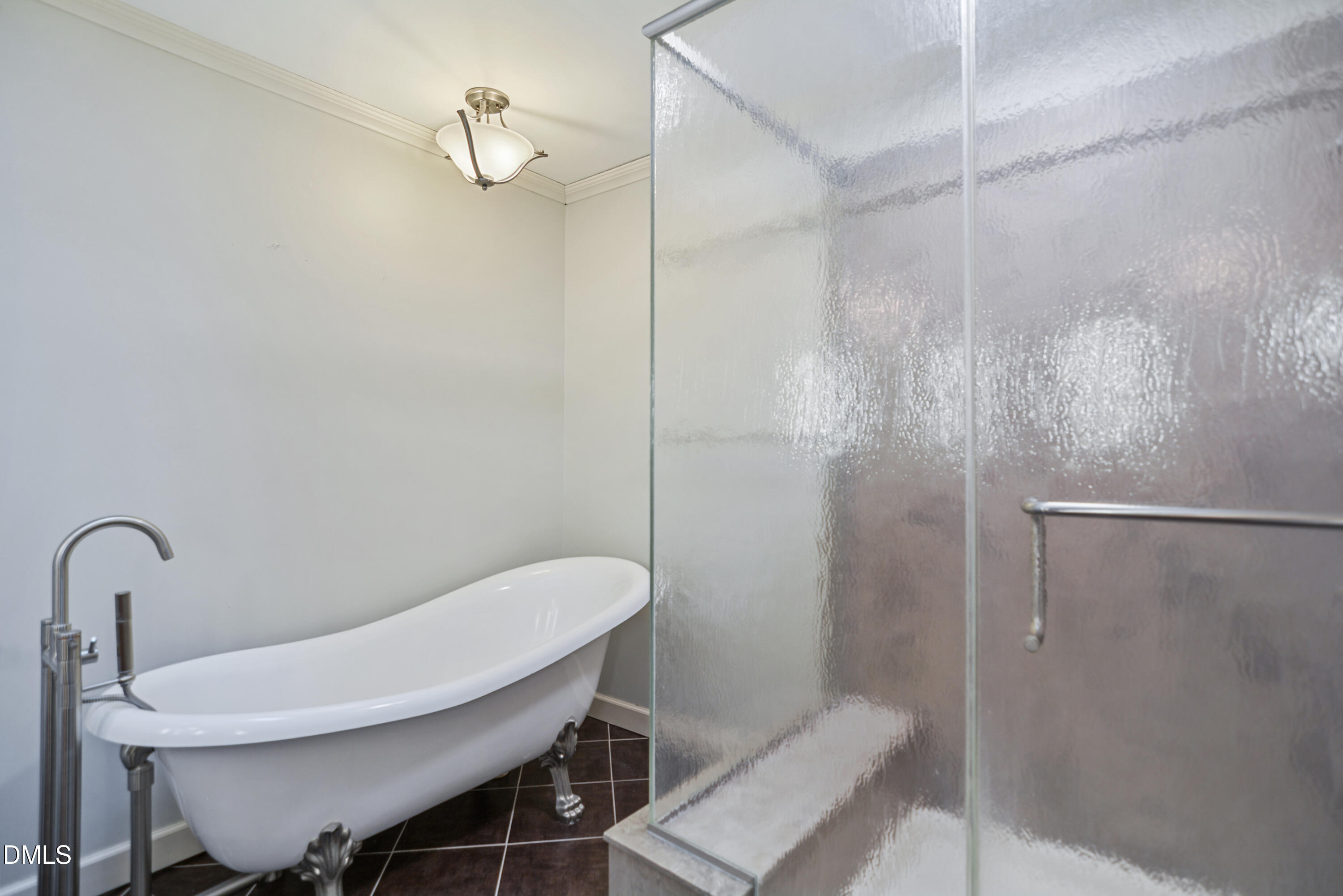 5008 Wood Valley Drive Raleigh, NC 27613 - Photo 18 of 37 a bathroom with a sink a toilet and shower