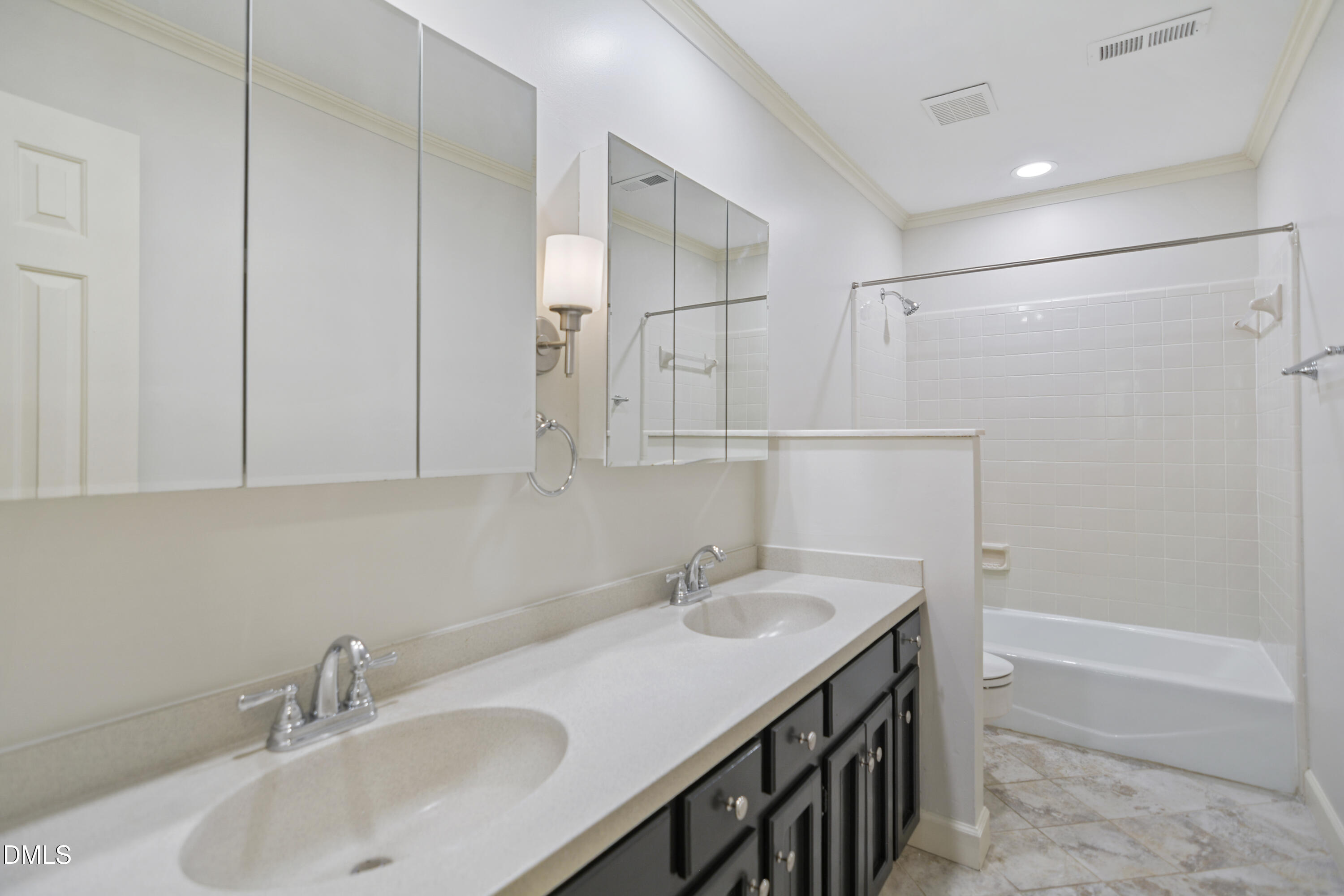 5008 Wood Valley Drive Raleigh, NC 27613 - Photo 22 of 37 a bathroom with a sink and a mirror