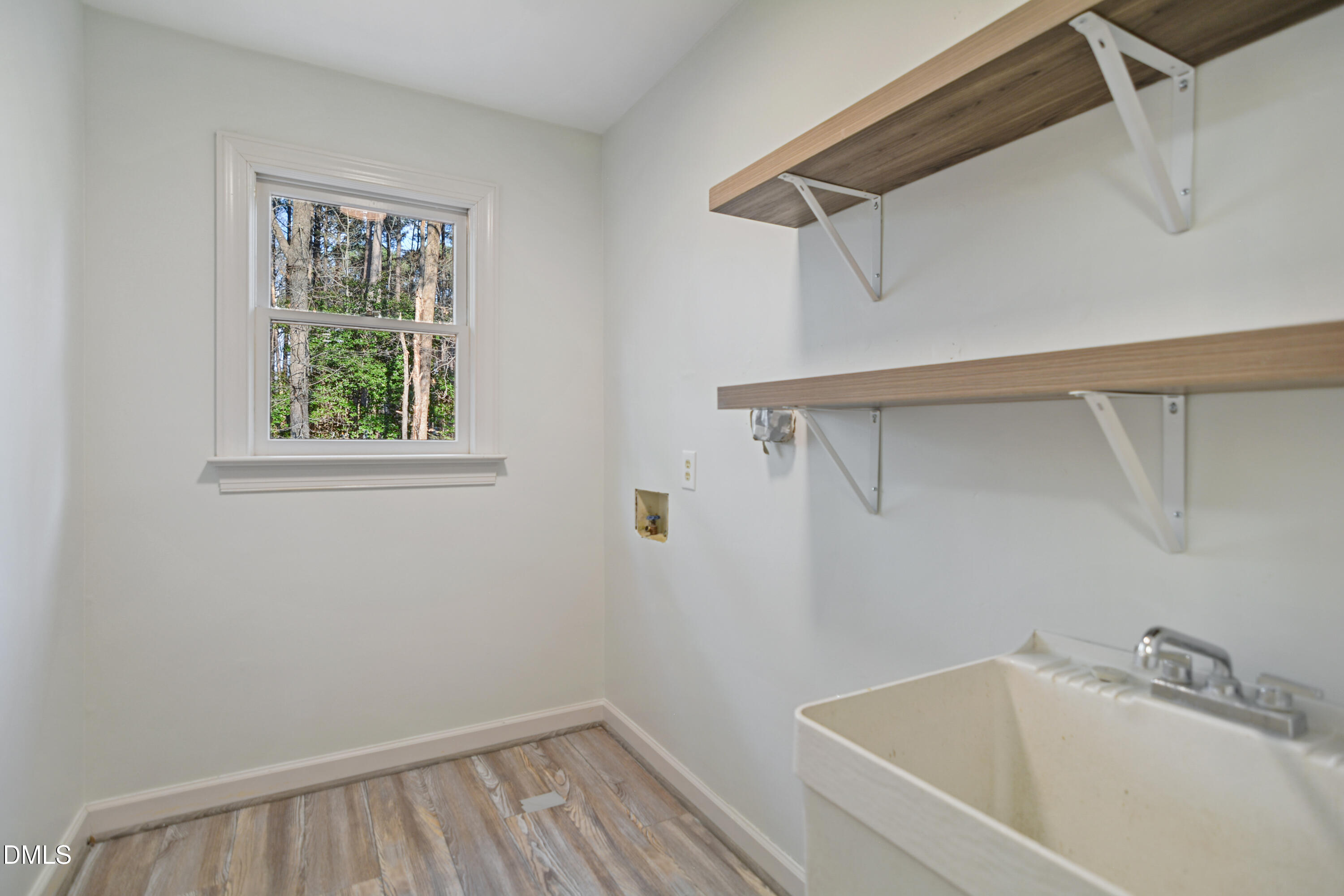 5008 Wood Valley Drive Raleigh, NC 27613 - Photo 26 of 37 a bathroom with a bathtub and window