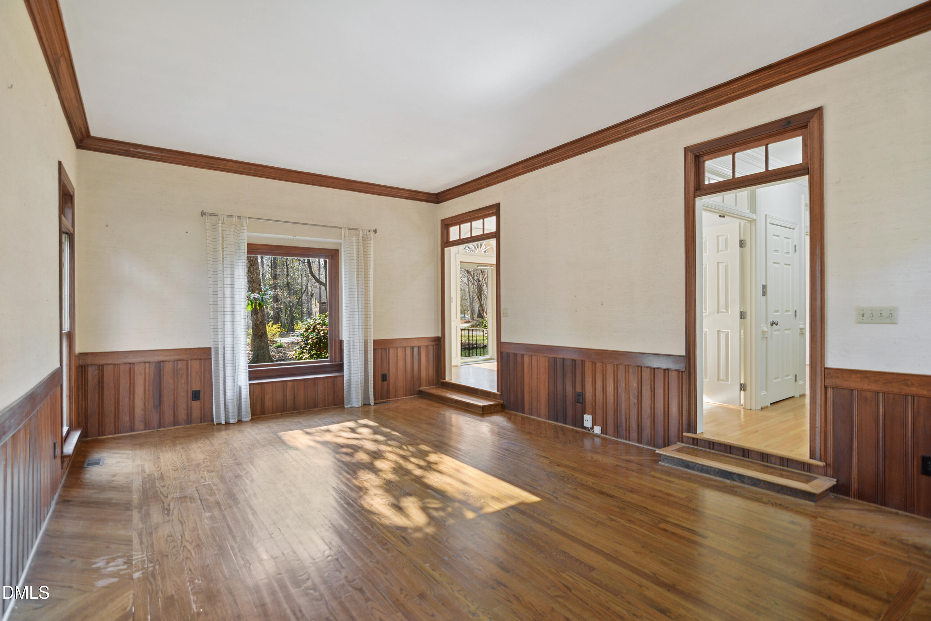 5008 Wood Valley Drive Raleigh, NC 27613 - Photo 6 of 37 an empty room with wooden floor and windows