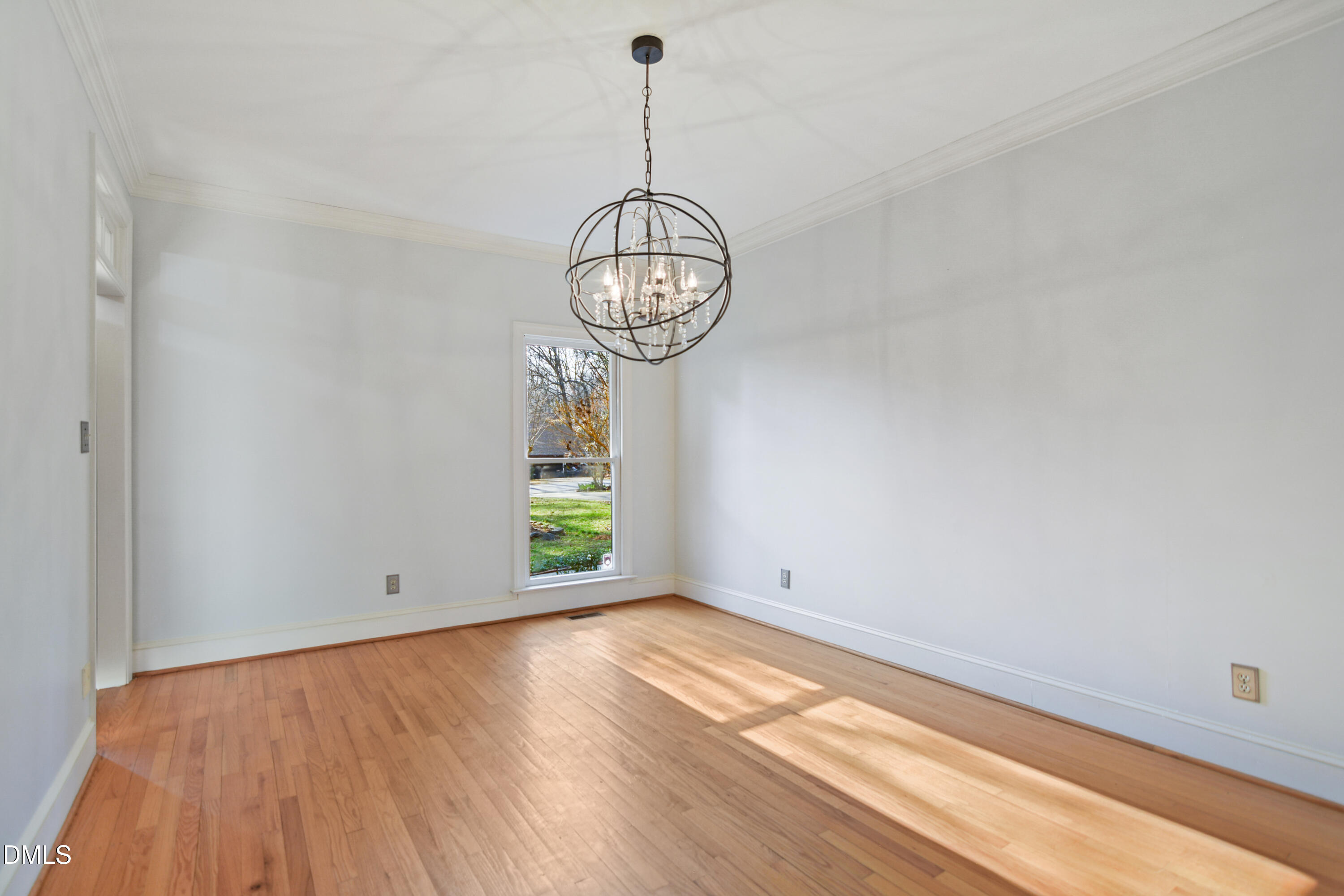 5008 Wood Valley Drive Raleigh, NC 27613 - Photo 7 of 37 a view of empty room with wooden floor and window