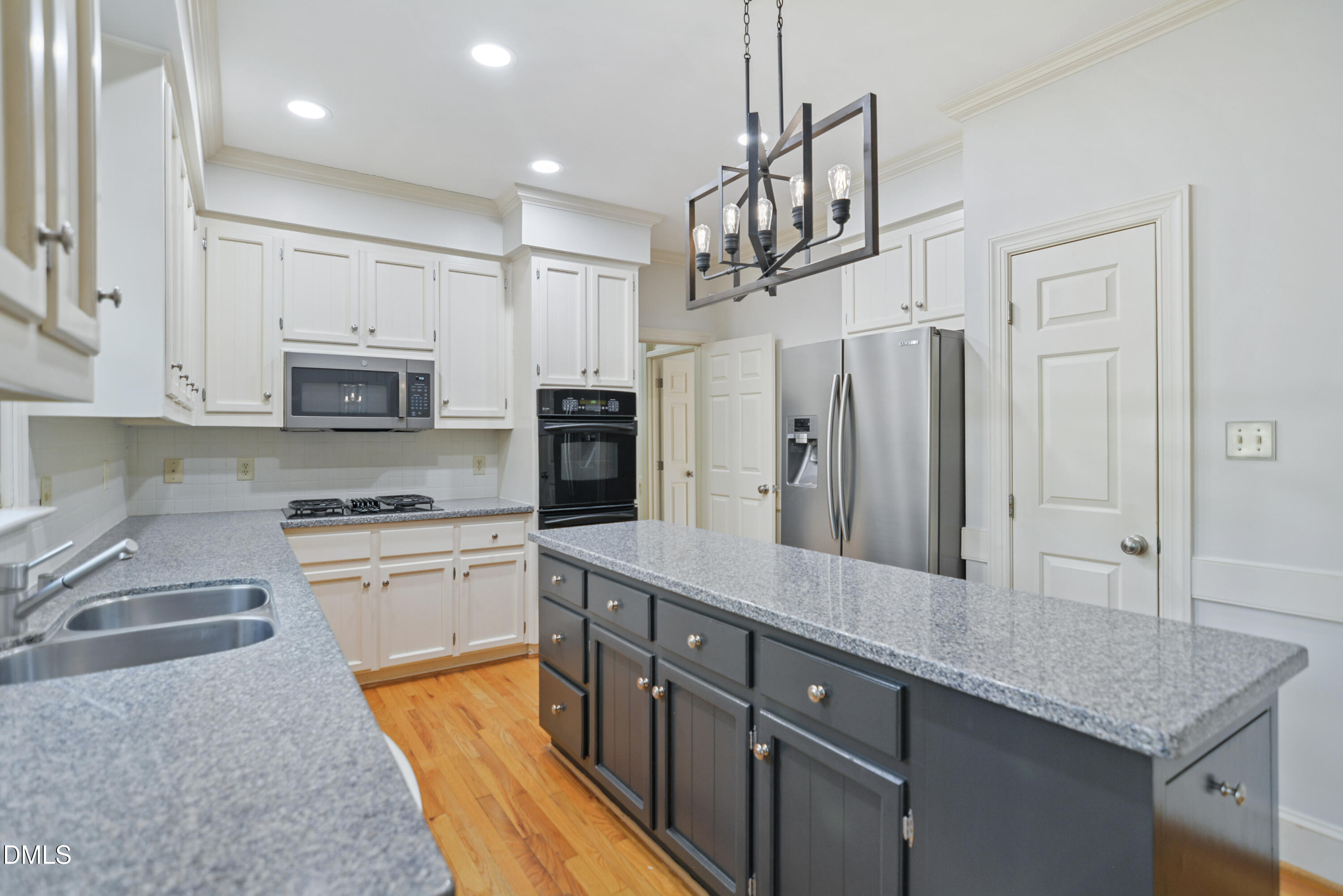 5008 Wood Valley Drive Raleigh, NC 27613 - Photo 8 of 37 a kitchen with stainless steel appliances granite countertop a refrigerator a stove microwave and white cabinets