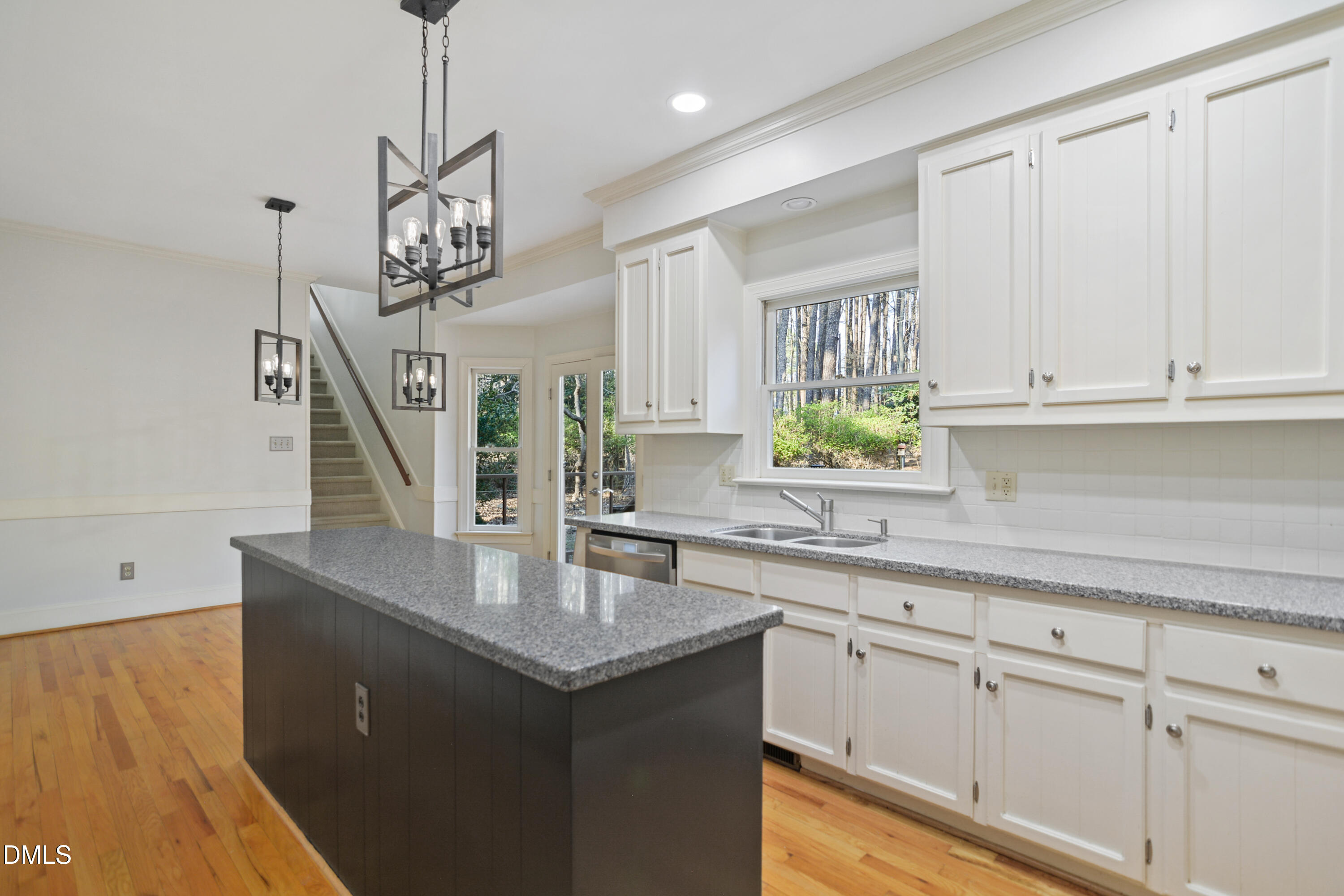 5008 Wood Valley Drive Raleigh, NC 27613 - Photo 10 of 37 a kitchen with stainless steel appliances granite countertop a sink a stove and a wooden floors