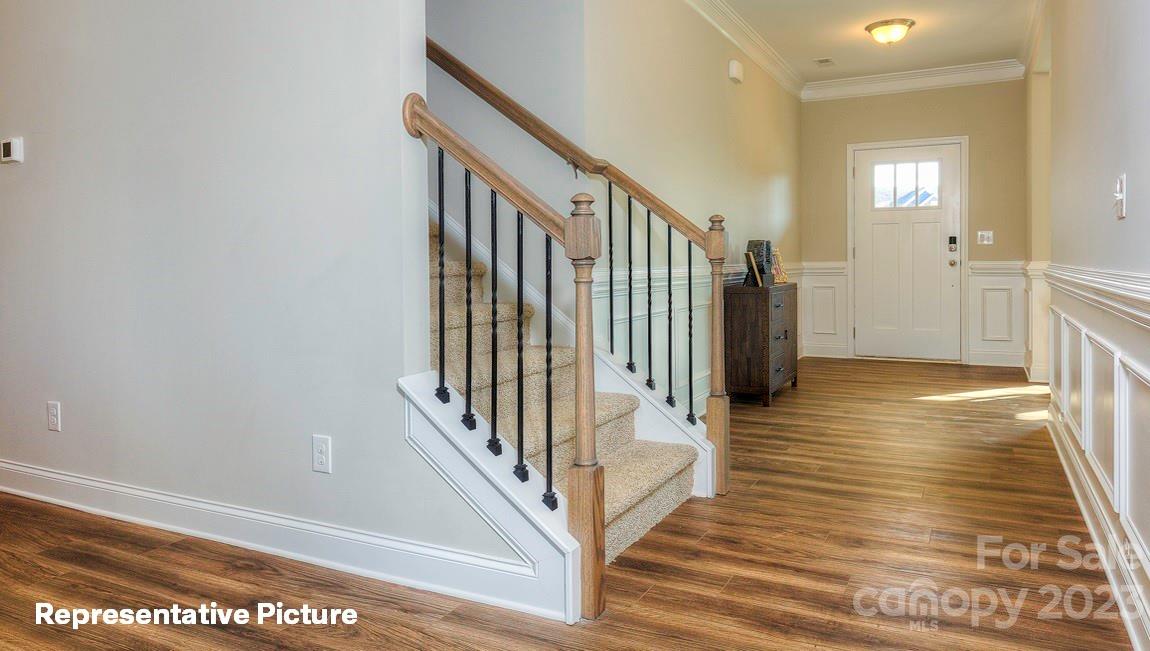 312 Streamwood Road Troutman, NC 28166 - Photo 3 of 39 a view of a hallway with wooden floor and staircase