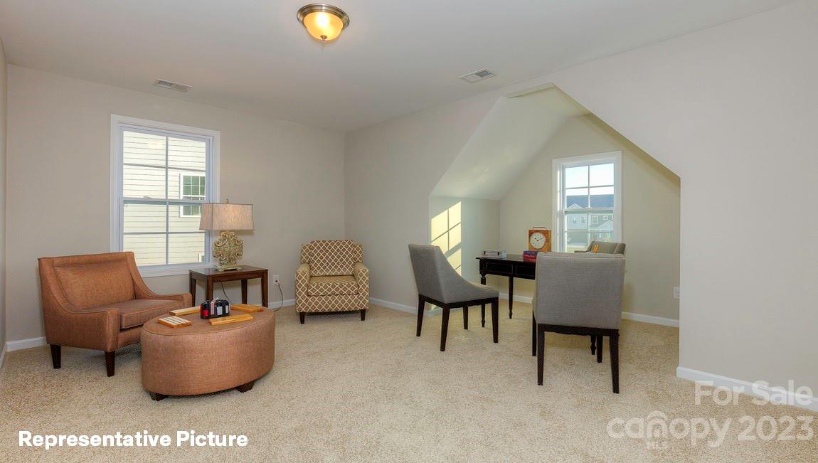 312 Streamwood Road Troutman, NC 28166 - Photo 32 of 39 a living room with furniture and a window