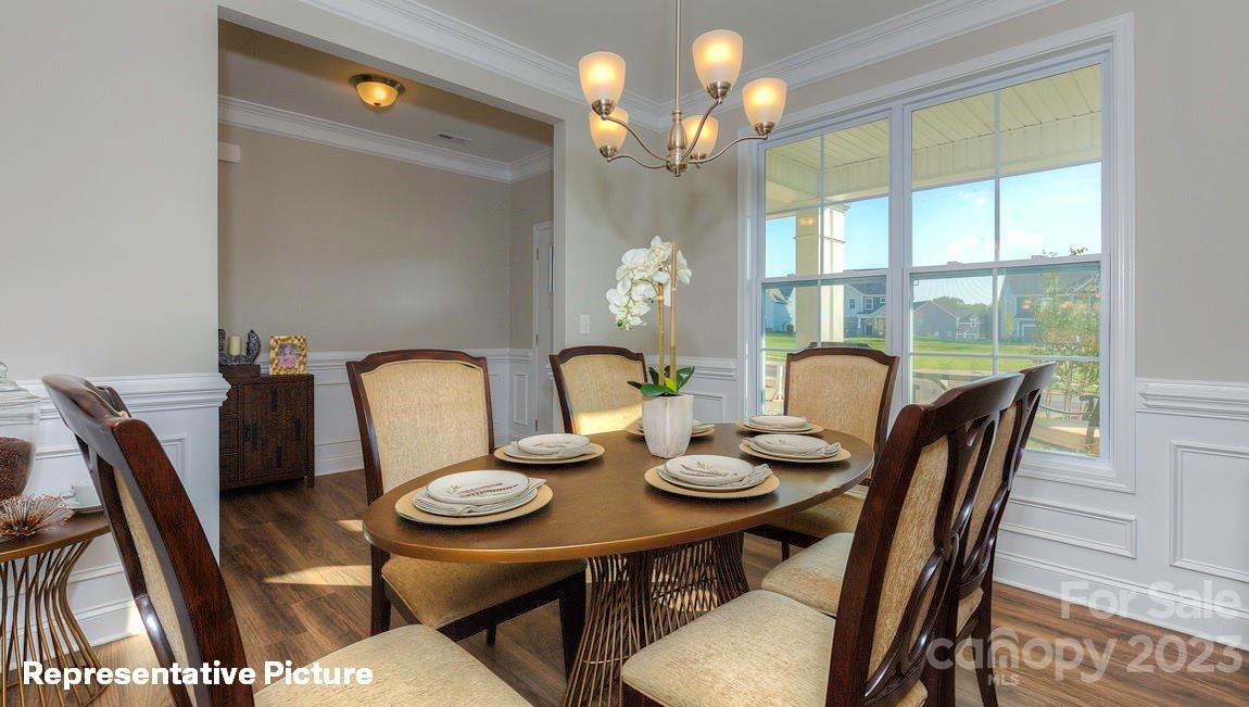 312 Streamwood Road Troutman, NC 28166 - Photo 4 of 39 a view of a dining room with furniture and chandelier