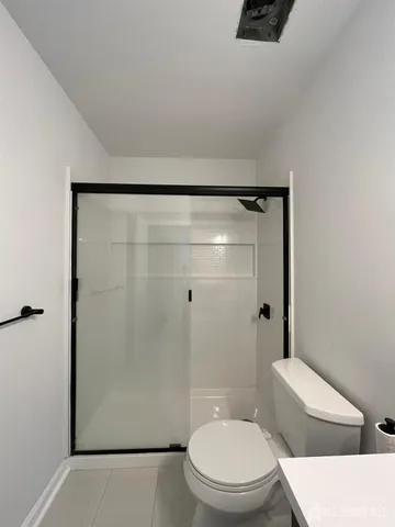 a white toilet sitting next to a bathroom sink