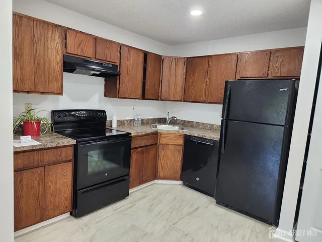 a kitchen with a refrigerator stove and cabinets