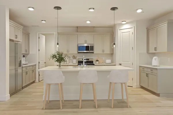 a kitchen with a sink and chairs