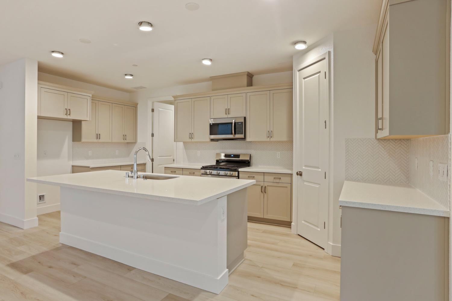 2182 Silk Avenue Manteca, CA 95337 - Photo 6 of 29 Laundry tucked behind kitchen