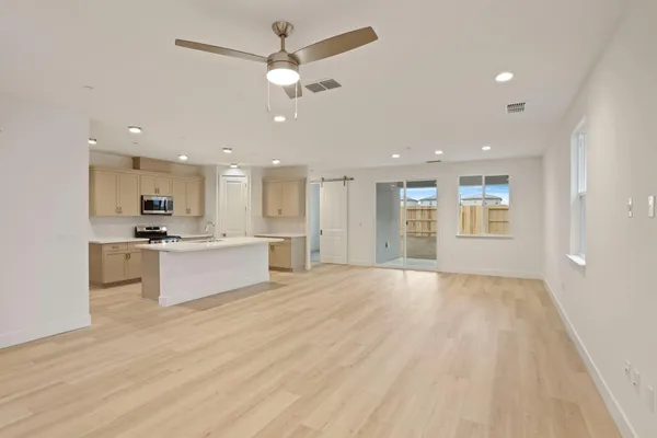 a view of kitchen with sink and refrigerator