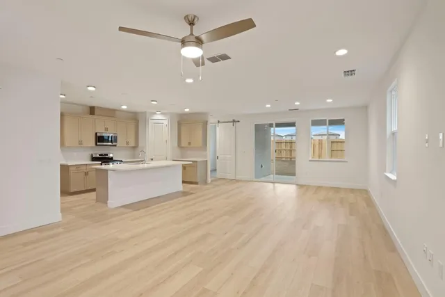 a view of kitchen with sink and refrigerator