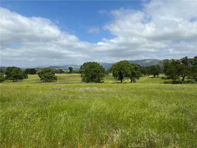 a view of a green field with house