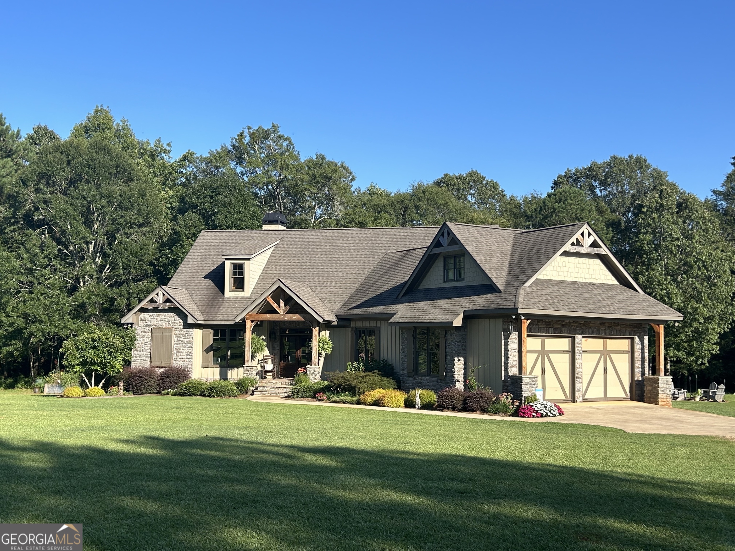 2400 Reese Road Rutledge, GA 30663 - Photo 1 of 1 a front view of a house with a garden