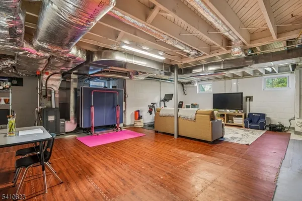 a living room with furniture and flat screen tv