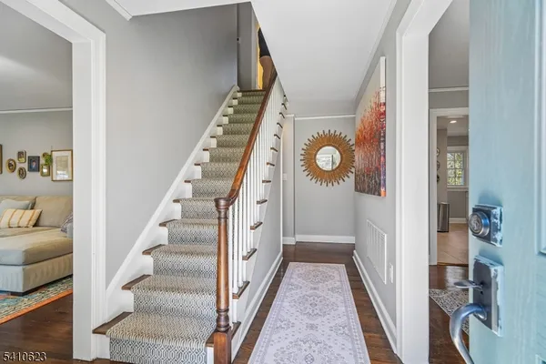 a view of a hallway with wooden floor and entryway