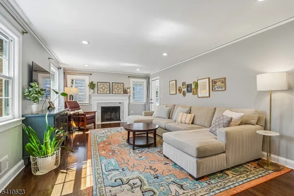 a living room with furniture large window and a fireplace