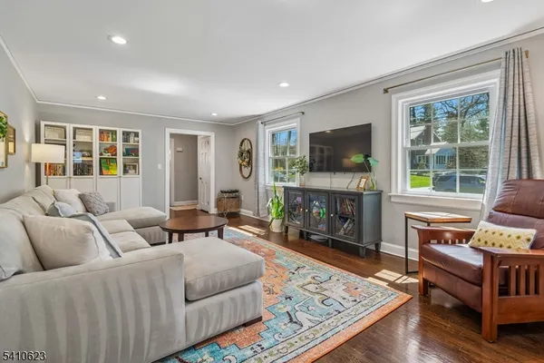 a living room with furniture a fireplace a flat screen tv and a fireplace