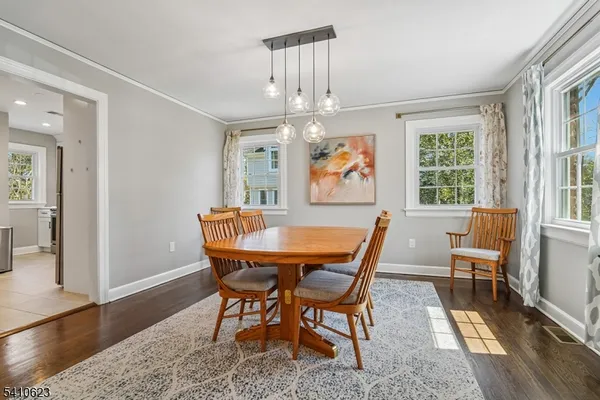 a dining room with furniture a rug a rug and a chandelier
