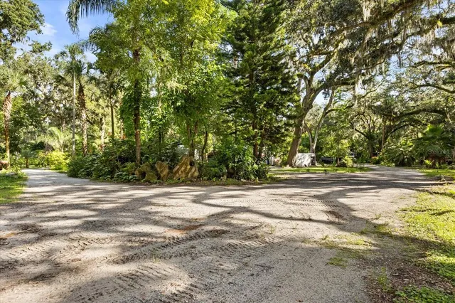 a view of a patio with table and chairs under an umbrella