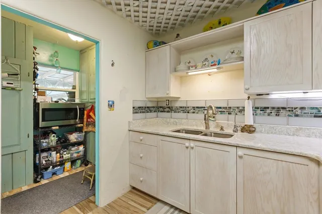 a living room with furniture a flat screen tv and a large window