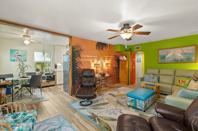 a bed sitting in a bedroom and a large window