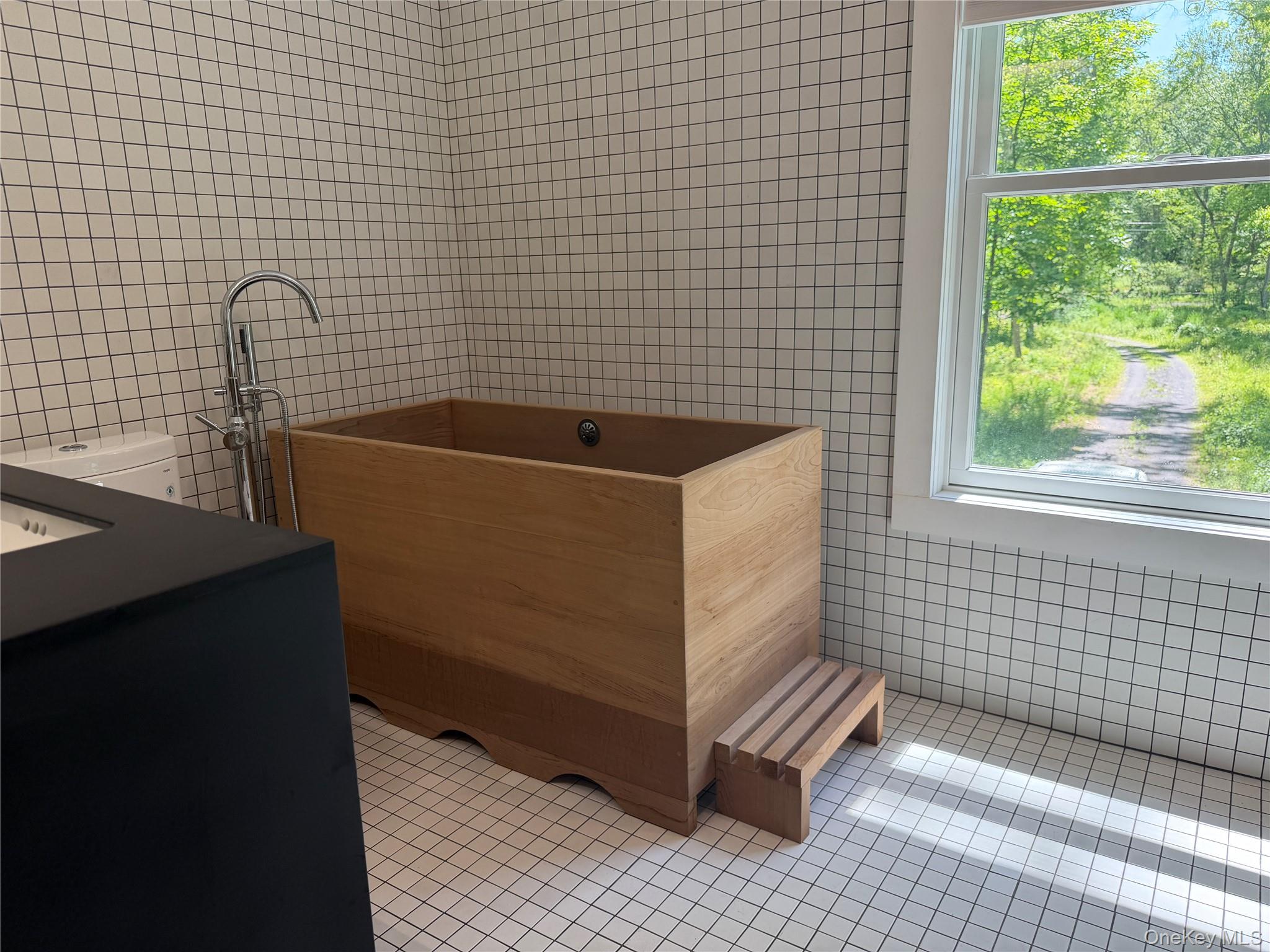 40 Pioneer Road Gardiner, NY 12525 - Photo 11 of 16 a bathroom with a bathtub and next to a window
