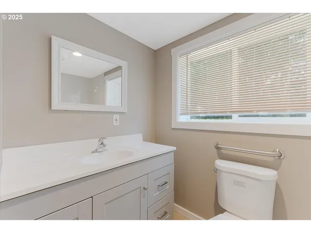 a bathroom with a sink a vanity and a mirror
