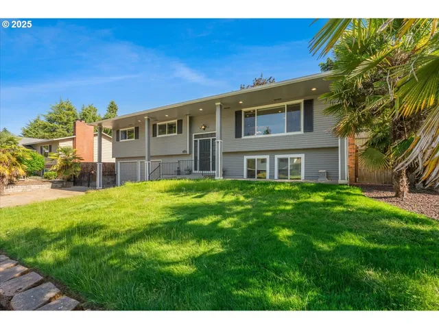 a front view of house with yard and green space